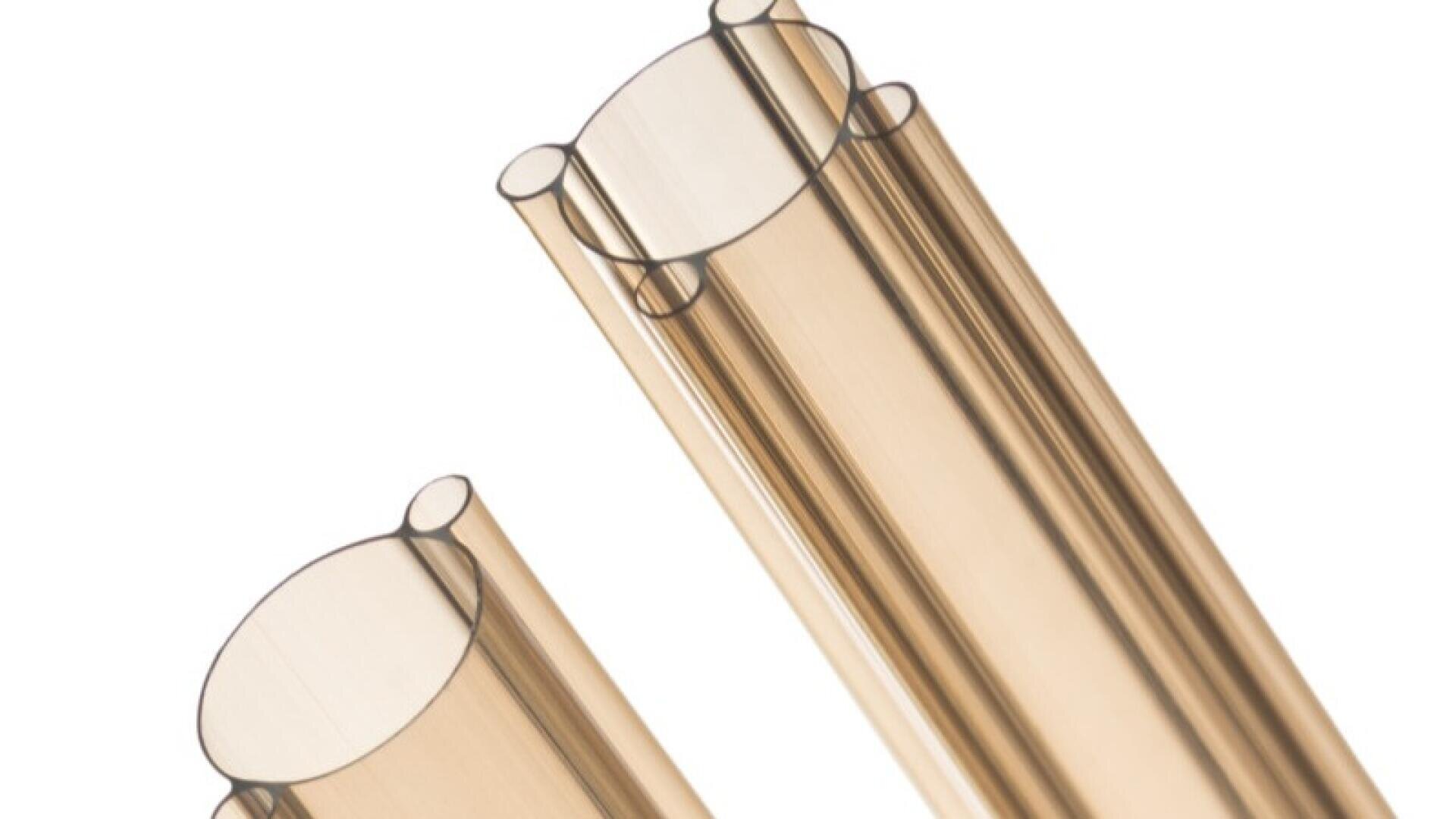 Close-up of two beige, transparent, oval-shaped plastic tubes placed side by side on a white background. The tubes appear shiny and smooth, with openings facing upward.