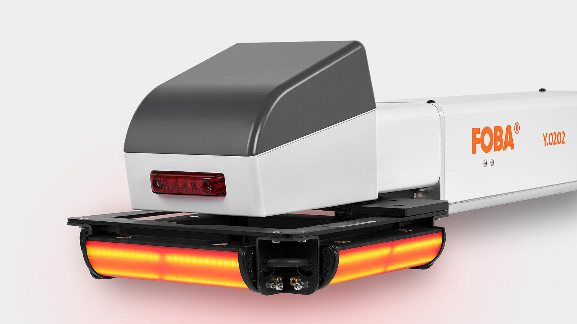 Close-up of a FOBA Y.0202 industrial laser marking machine showing its gray and white housing, red FOBA logo, and orange lights on the lower front section against a plain background.